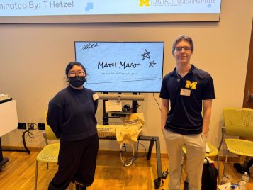 Yeji Kim and Anthony McLean standing by a screen with their project, "Math Magic."